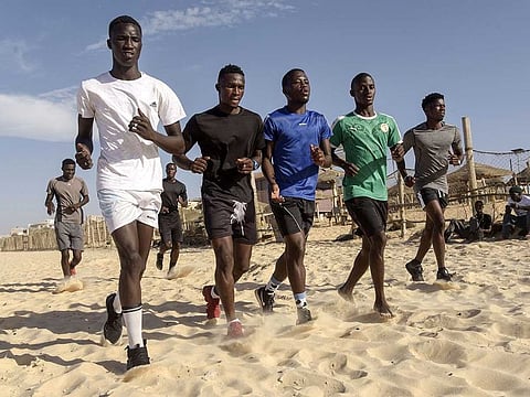 Young Senegaleses work out on a beach in the popular Yoff Neighbourhood in Dakar, on November 24, 2020. With a mostly youthful population of some 16 million people, Senegal recorded some 16,000 coronavirus cases and 331 deaths to date, according to the health ministry. The country became an international poster child for its handling of the coronavirus pandemic, but the reason behind its success still divides experts. 