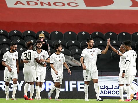 Al Jazira's Ali Mabkhout celebrates his opener against Hatta
