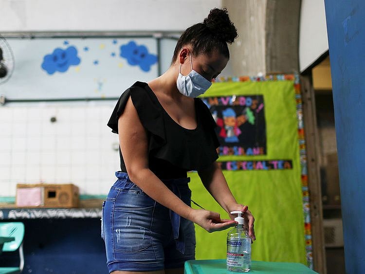 A woman uses hand sanitizer