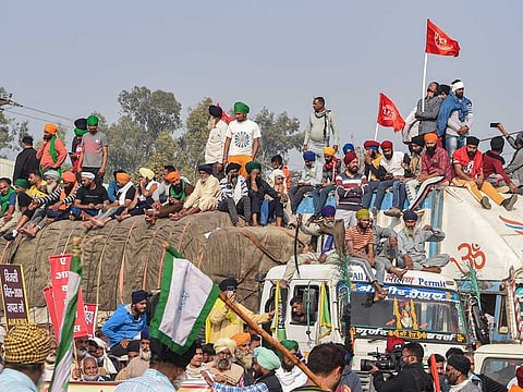 Farmers gather at the Singhu border during their ongoing 'Delhi Chalo' protest against the goverment's new farm laws, in New Delhi, Monday, Nov 30, 2020. 