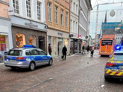 Police cars and an ambulance are seen at the scene where a car drove into pedestrians in Trier, southwestern Germany, on December 1, 2020. 