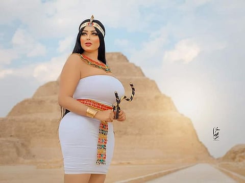 The woman, identified as Salma Al Shimi, provoked an outcry after she released the images showing her clad in Pharaonic outfits and posing in front of the Step Pyramid and other monuments in Giza south of Cairo.