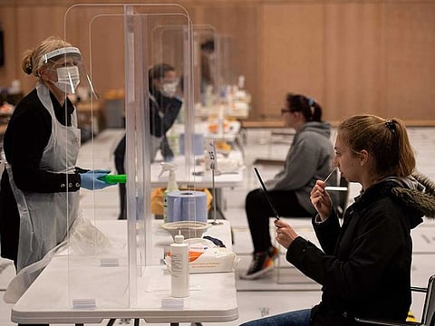 A student takes a swab for a lateral flow COVID-19 test in Hull, northern England. A report citing UK health data shows that widespread immunity (through previous infection or vaccination, oor both) as well as the emergence of Omicron has helped the population reach a stage where COVID is now less fatal than the flu. The data needs to be validated in places.