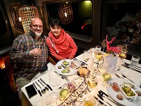 Joerg and Diana Schimmel sit in their motorhome as they enjoy a high class-dinner served by a culinary school during the spread of the COVID-19 in Neumuenster, Germany. 