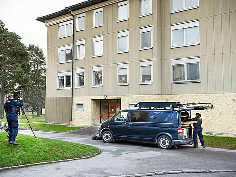 Police at the scene of an apartment where a woman is suspected of locking up her son, in Haninge, south of Stockholm. 