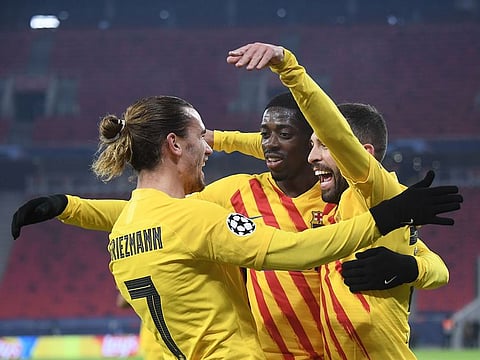 Barcelona's French midfielder Antoine Griezmann (L) celebrates scoring with his team-mates.