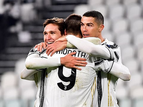 Cristiano Ronaldo (R) celebrates with Juventus teammates Alvaro Morata (centre) and Federico Chiesa.