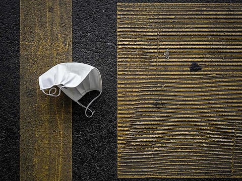 A discarded protective face mask.