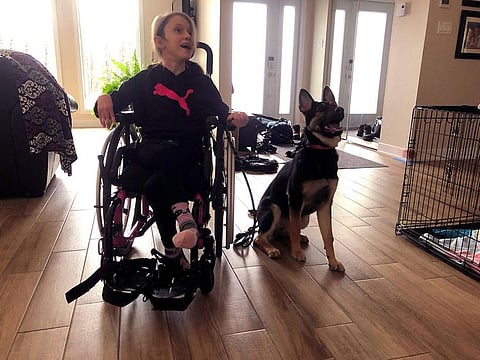 Oceane McKenzie, 11, who suffers from cerebral palsy, is seen with her new puppy Oakley at home in L’Ange-Gardien, Quebec, on December 1, 2020.