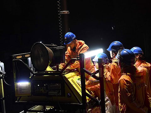 Rescuers adjust an emergency generator at the Diaoshuidong coal mine in southwestern China's Chongqing, after a carbon monoxide leak at the facility left 18 dead, with rescue efforts under way to reach five others still trapped underground. 