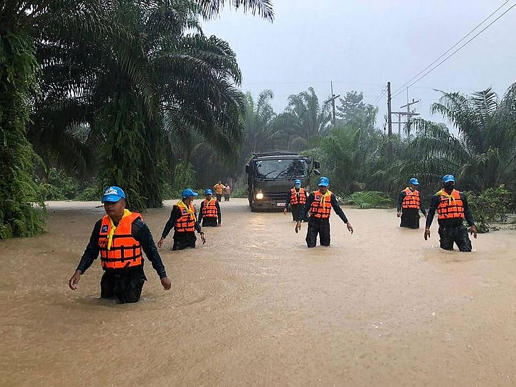 Security forces wading through flood waters
