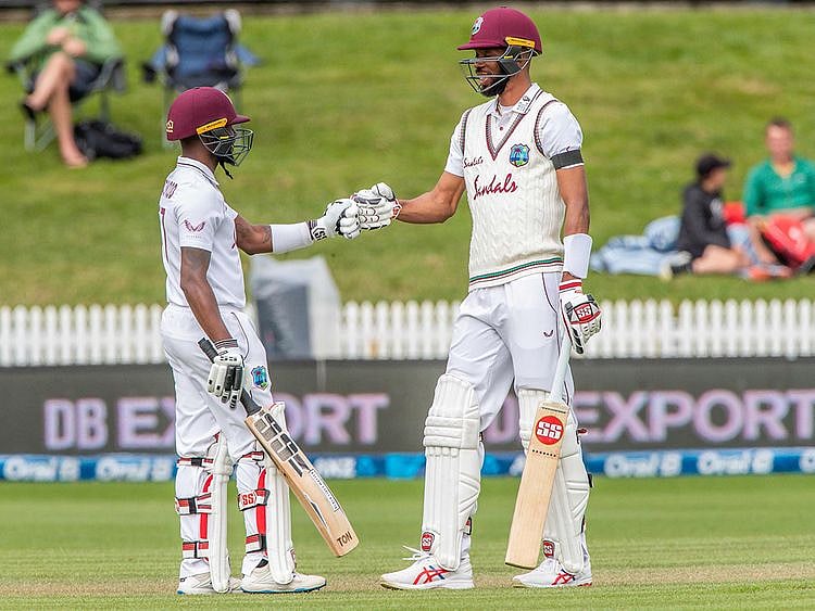 West Indies' Jermaine Blackwood  (L) and Roston Chase touch gloves during the third day of the first Test cricket match between New Zealand and West Indies