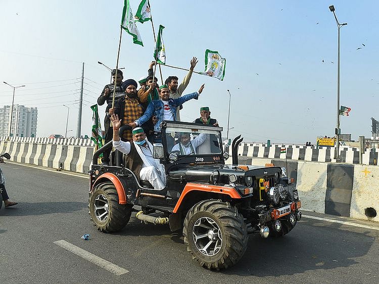 New Delhi: Bharatiya Kisan Union Spokesperson Rakesh Tikait rides a jeep along with others during farmers' 'Delhi Chalo' protest march against the new farm laws, at Ghazipur border (Delhi-UP border) on NH-24 in New Delhi, Sunday, Dec. 6, 2020. 