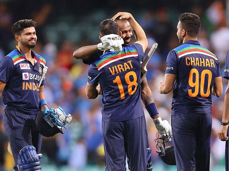 Virat Kohli (2nd L) gives a hug to a teammate Hardik Pandya