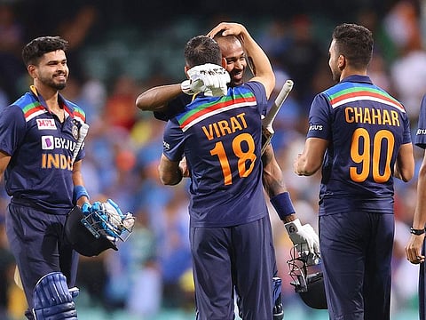India's captain Virat Kohli (2nd L) gives a hug to a teammate Hardik Pandya as the team celebrate victory against Australia in the second T20 at the Sydney Cricket Ground. 
