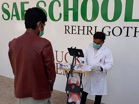 A prospective blood donor of Rehri Goth area observes proper social distancing to participate in the screening process prior to donating his blood to the Indus Hospital, Karachi.