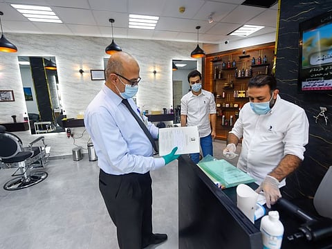 Sharjah Municipality Health Inspector Amjad Hussein inspects a salon at Al Majaz. 