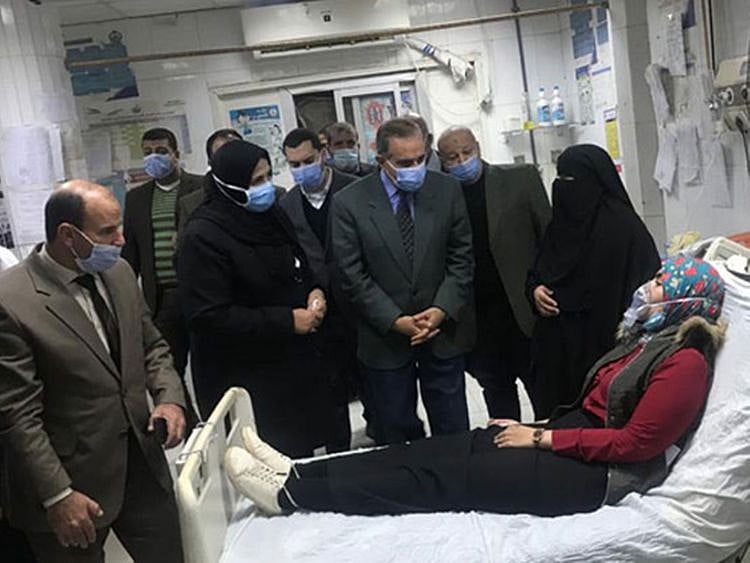 Local officials visit a woman hospitalised due to a chlorine leak in the Egyptian Delta province of Kafr Al Sheikh. 