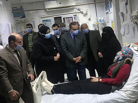 Local officials visit a woman hospitalised due to a chlorine leak in the Egyptian Delta province of Kafr Al Sheikh. 