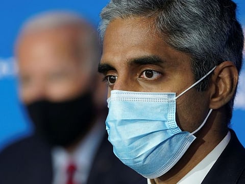 US President-elect Joe Biden listens with Dr. Vivek Murphy, Biden's nominee to be US Surgeon General, during a news conference at Biden's transition headquarters in Wilmington, Delaware, U.S., December 8, 2020. 