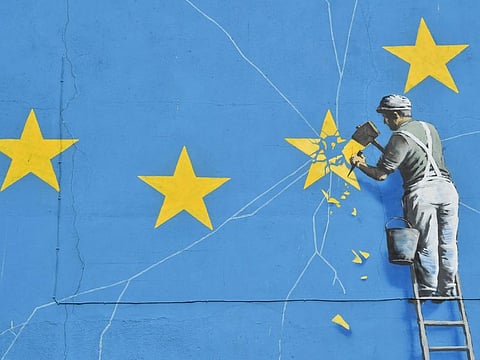 This file photo taken on January 07, 2019 shows a mural by British artist Banksy, depicting a workman chipping away at one of the stars on a European Union themed flag in Dover, south east England. 