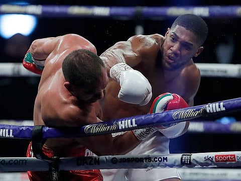 World Heavyweight boxing champion Anthony Joshua lands a blow on Bulgaria's Kubrat Pulev during their heavyweight title fight at Wembley Arena 