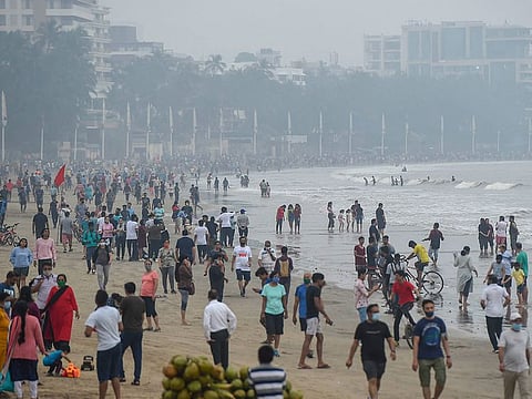 People visit Juhu Beach in the morning hours, in Mumbai, on December 13, 2020. 