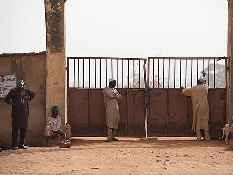 Parents wait outside the Government Science Secondary school in Kankara, in northwestern Katsina State, Nigeria on December 16, 2020.