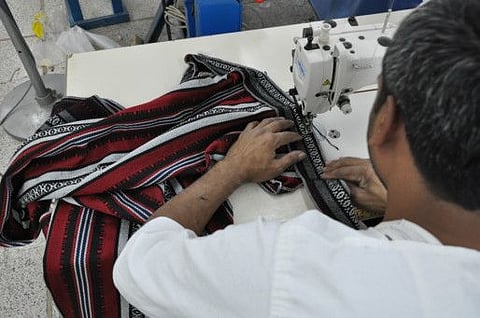 An inmate works on a garment at Al Aweer jail in Dubai. Picture for illustrative purposes only.