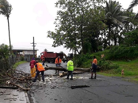 People remove debris due to Cyclone Yasa at Velau Drive in Fiji, December 18, 2020, in this image obtained via social media