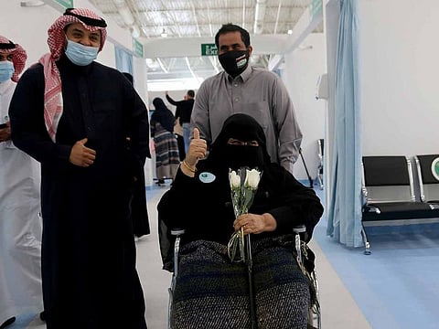 A Saudi woman gestures after she received the first dose of a coronavirus disease (COVID-19) vaccine, in Riyadh, Saudi Arabia December 17, 2020.