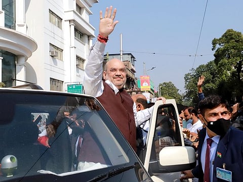 India Home Minister Amit Shah waves to supporters during his visit to Swami Vivekanand ancestral house, in Kolkata on Saturday. 