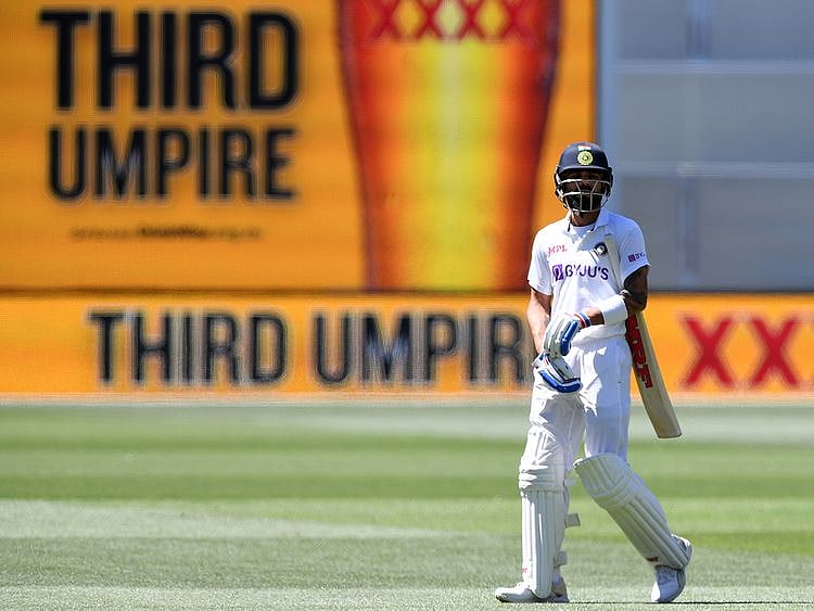 India's Virat Kohli waits as he walks off as the third umpire checks the catch that takes Kohli's wicket for 4 runs against Australia