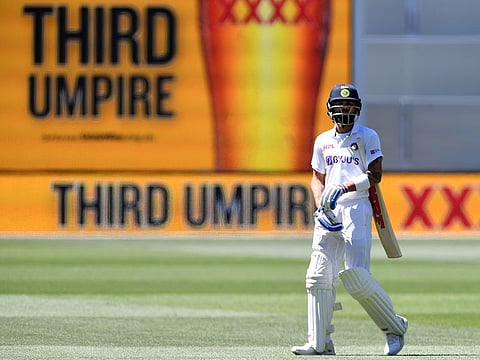 India's Virat Kohli waits as he walks off as the third umpire checks the catch that takes Kohli's wicket for 4 runs against Australia