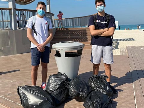 Assem Badreddine (right) with Robert Andonian during a garbage collection drive at a beach in Dubai.