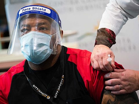 Health care worker Henri Keeling receives his first injection of the Pfizer-BioNTech COVID-19 vaccine at Contra Costa Regional Medical Centre in Martinez, Calif., Dec. 15, 2020. 