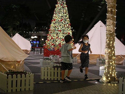 Children play a game of tag at Changi Airport's indoor glamping grounds after checking in, in Singapore, December 21, 2020. 