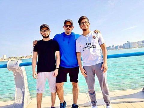 Physical Education teacher Harun Rashied with two of his students.