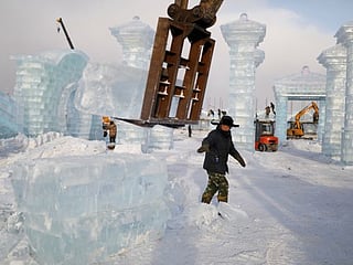 Photos: China 'mines' ice from river to build frozen castles, pagoda