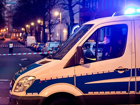 Policemen work at a crime scene in Berlin's Kreuzberg district, following a shooting that left four people injured. 