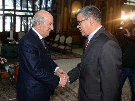A handout picture released by the official Algeria Press Service (APS) shows Algerian President Abdelaziz Tebboune (L) receiving the newly appointed Prime Minister Abdelaziz Djerad in the capital Algiers on December 28, 2019. 