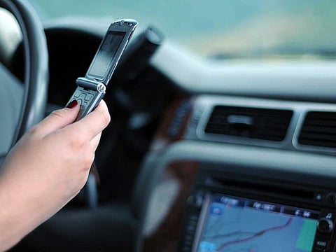 Abu Dhabi Police warned motorists that driving and playing games on mobile phones will incur a Dh800 fine and four black points. 