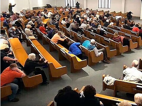 In this still frame from livestreamed video provided by law enforcement, churchgoers take cover while a congregant armed with a handgun, top left, engages a man who opened fire, near top center just right of windows, during a service at West Freeway Church of Christ, Sunday, Dec. 29, 2019, in White Settlement, Texas. The footage was broadcast online by the church according to a law enforcement official, who provided the image to The Associated Press on condition on anonymity because the investigation is ongoing.
