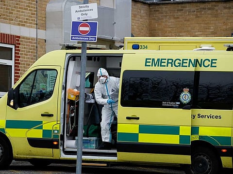A healthcare worker wearing personal protective equipment (PPE) gets out of the ambulance outside the Southend University Hospital, as the coronavirus disease (COVID-19) hospital admissions rise in the UK, in Southend-On-Sea, Britain December 31, 2020. 
