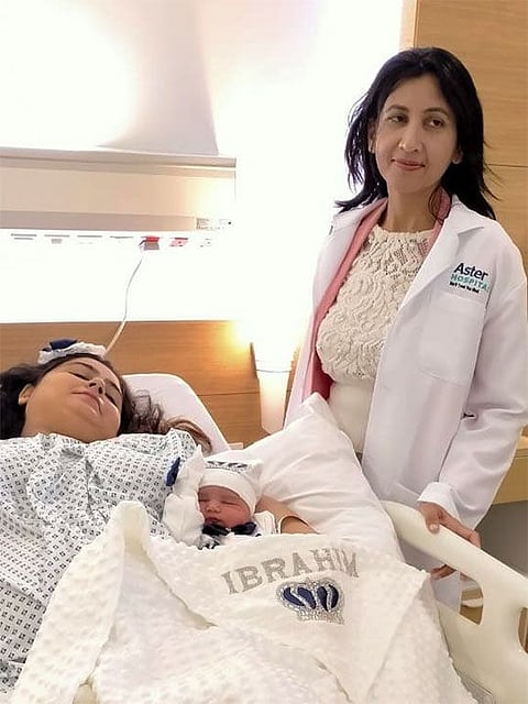  Dr Suchita Mehrishi, Specialist - Gynecology , Aster Hospital -  Qusais with the first baby born at 12 am midnight today  named Ibrahim and mother of the child Ms Ibra Khan.