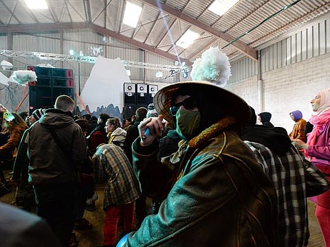 People dance during a party in a disused hangar in Lieuron about 40km (around 24 miles) on south of Rennes, on January 1, 2021.