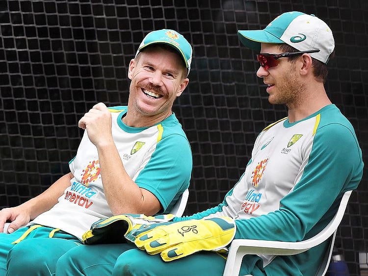 David Warner (L) chats with captain Tim Paine (R)