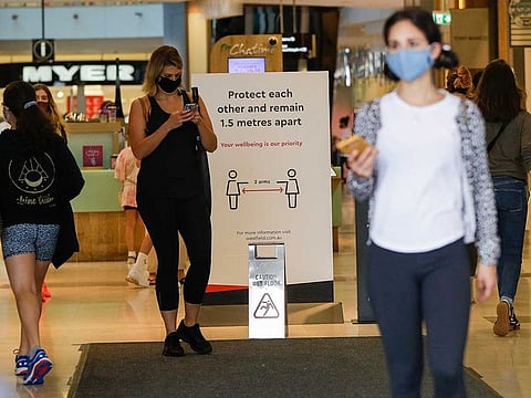 Shoppers wear masks as they walk around a shopping centre in Sydney, Australia, Sunday, Jan. 3, 2021. 