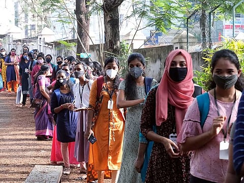 Students stand in a queue at Women's college as it reopens for students following the COVID-19 outbreak, in Thiruvananthapuram on Monday, January 4, 2021. 