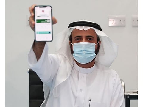 Saudi Health Minister Dr. Tawfiq Al Rabiah displays the health passport service. 